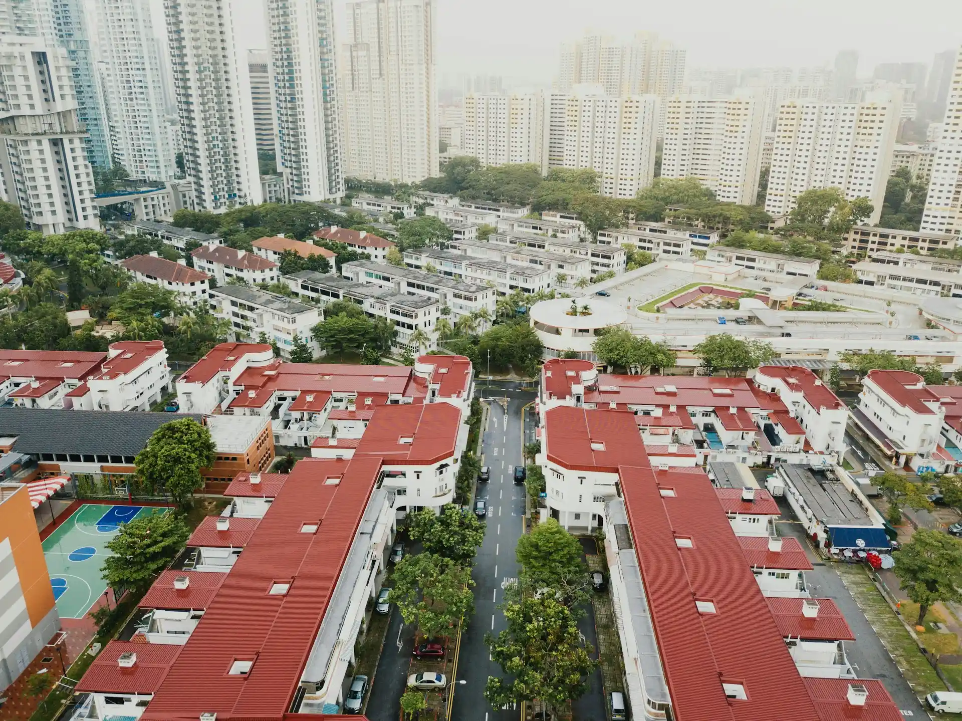 An aerial view contrasting modern high-rise buildings with lower-rise residential areas, illustrating the diverse application of real estate development strategies for urban areas.